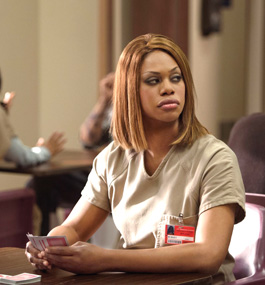 actor laverne cox, dressed in prison garb and wearing a prison ID, in a scene from "orange is the new black."